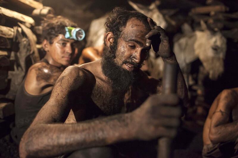 A miner wipes sweat from his forehead inside a coal mine in Choa Saidan Shah, Punjab. Sara Farid / Reuters