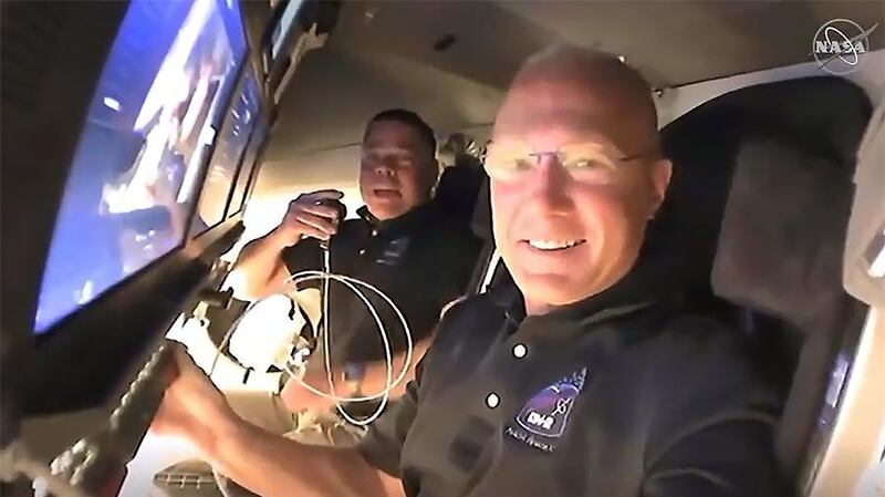 Nasa astronauts Doug Hurley, foreground, and Bob Behnken call down to mission controllers for a report on their second flight day onboard the SpaceX Crew Dragon spacecraft on Nasa's SpaceX Demo-2 mission approaching to dock to the International Space Station (ISS). Nasa TV / EPA