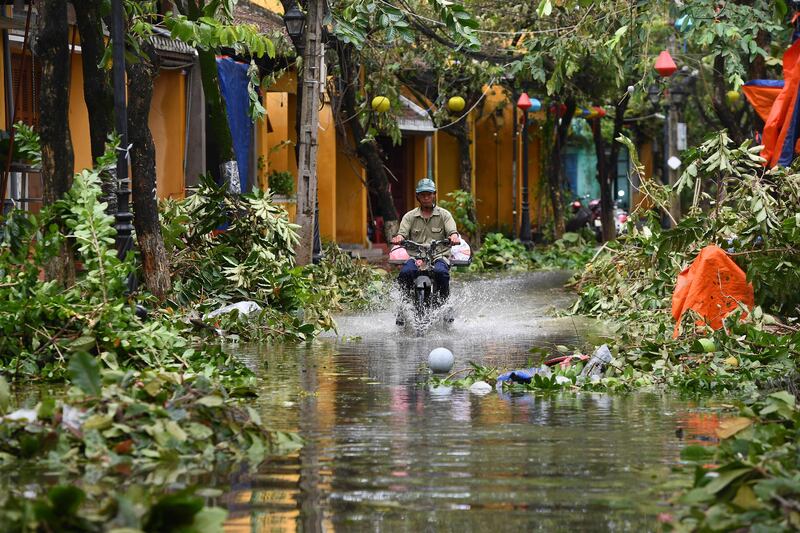 A man rides a motorbike in a flooded street following the passage of Typhoon Noru in Hoi An city, Vietnam. AFP