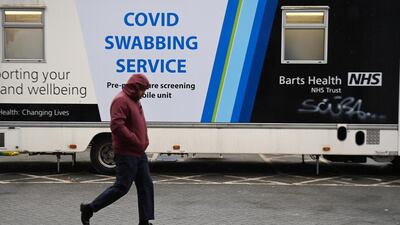 A pedestrian walks past a mobile Covid-19 test centre in London. EPA