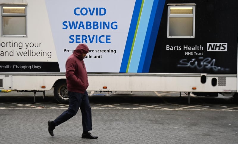 A pedestrian walks past a mobile Covid-19 test centre in London. EPA