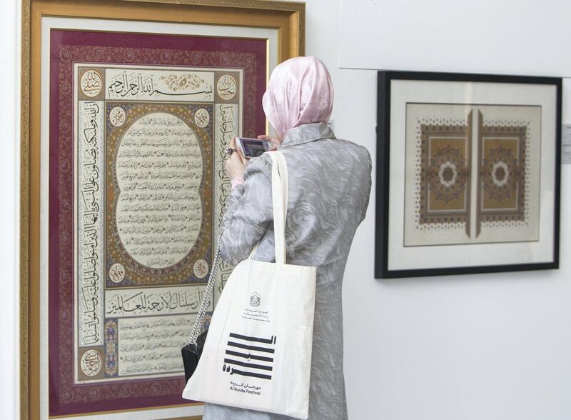 ABU DHABI, UNITED ARAB EMIRATES -An attendee looking at an artwork at the Al Burda Festival, Shaping the Future of Islamic Art and Culture at Warehouse 421, Abu Dhabi.  Leslie Pableo for The National for Melissa Gronlund���s story