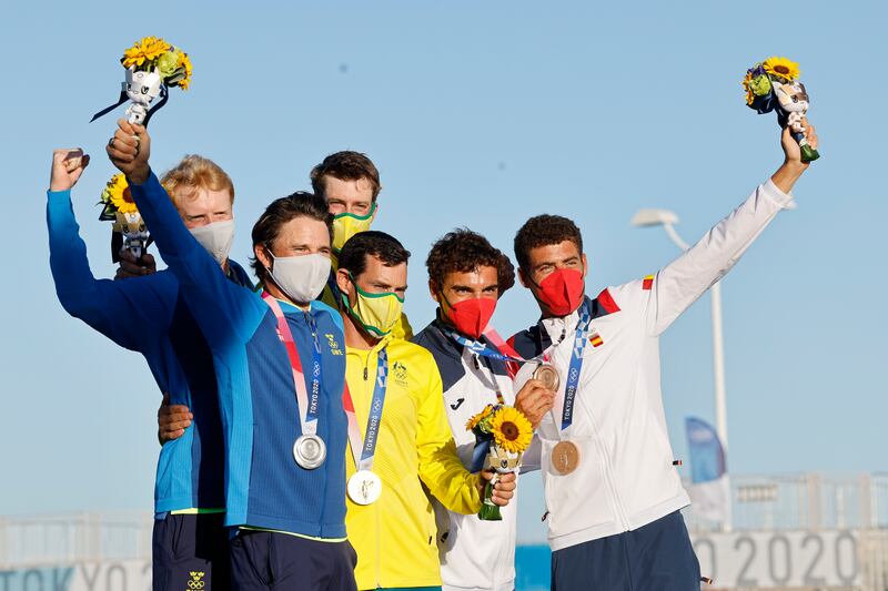 Silver medalists Fredrik Bergstrom and Anton Dahlberg of Sweden, gold medalists Mathew Belcher and Will Ryan of Australia and bronze medalists Nicolas Rodriguez Garcia-Paz and Jordi Xammar of Spain pose after the Men's Two Person Dinghy medal race.