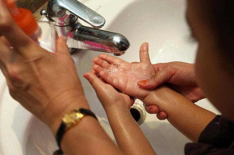 DUBAI. 31st August. 2009. SWINE FLU PRECAUTIONS . Moatasem Nada (3) has his hands washed as a precaution against Swine Flu as children were given an extra morning hand wash at the British Orchard Nursery in Dubai yesterday( mon). Stephen Lock  /  The National . *** Local Caption ***  SL-wash-006.jpg