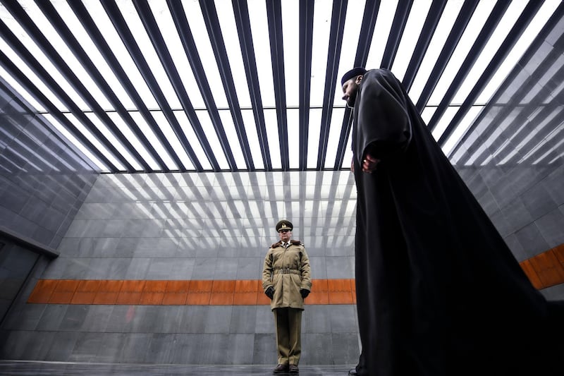 An orthodox priest walks after paying respects at the Holocaust memorial in Bucharest, Romania, Monday, Jan. 27, 2020. Romania marked the International Holocaust Remembrance Day on the 75th anniversary of the Soviet army's liberation of the Auschwitz-Birkenau death camp. AP Photo
