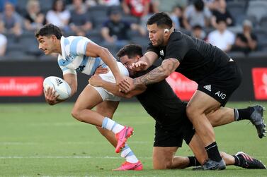 TOPSHOT - Ndew Zealand's Anton Lienert-Brown (C) and Tyrel Lomax (R) tackle Argentina's Santiago Carreras (L) during the 2020 Tri-Nations rugby match between the New Zealand and Argentina at Bankwest Stadium in Sydney on November 14, 2020. / IMAGE RESTRICTED TO EDITORIAL USE - STRICTLY NO COMMERCIAL USE / AFP / David Gray / / IMAGE RESTRICTED TO EDITORIAL USE - STRICTLY NO COMMERCIAL USE