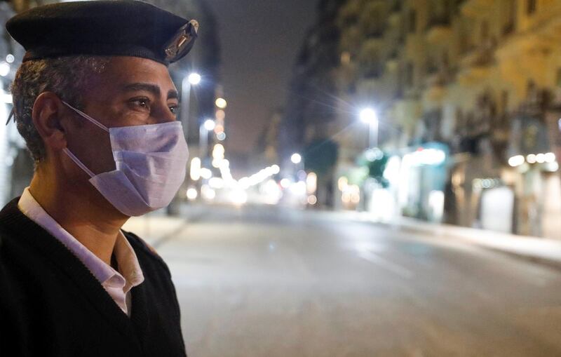 A police officer stands at the Qasr El Nil street during the first day of a two-week night-time curfew which was ordered by the Egyptian Prime Minister Mostafa Madbouly to contain the spread of the coronavirus disease, in Cairo, Egypt. Reuters