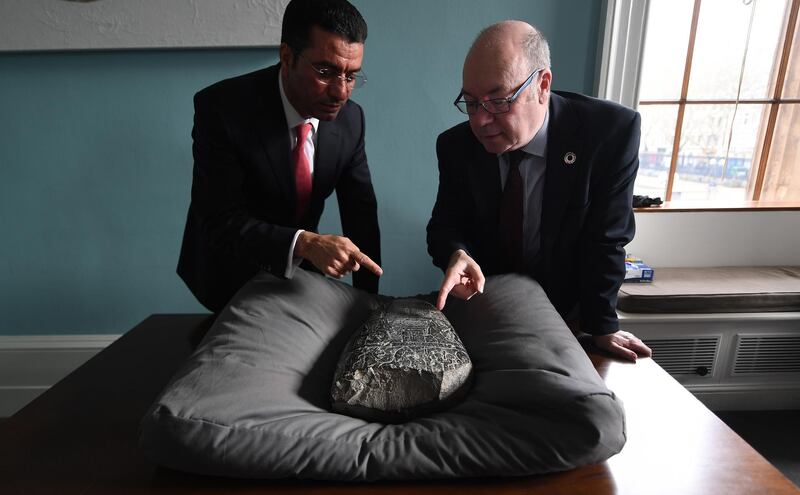 epa07447943 His Excellency Dr Salih Husain Ali (L) with British Minister of the Middle East and North Africa Alistair Burt with an Iraqi 'kudurru' (boundary stone) at the British Museum in London, Britain, 19 March 2019. The kudurru is set to be returned to Iraq from the British Museum. The stone was seized at Heathrow Airport by UK Border Force in 2012. Many archaeological sites in southern Iraq were looted between 1994 and 2004.  EPA/ANDY RAIN