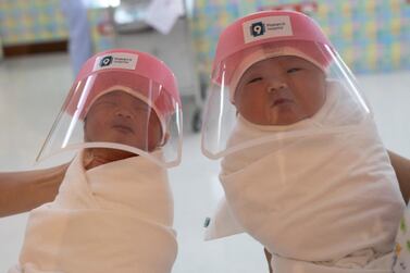 Nurses hold newborn babies wearing protective face shields during the coronavirus disease outbreak at the Praram 9 hospital in Bangkok, Thailand. Reuters