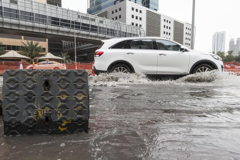 Motorists navigate flooded streets in Barsha Heights. Antonie Robertson / The National