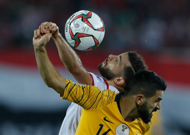 Australia's Aziz Behich, foreground, challenges for the ball with Syria's Mahmoud al Maowas. AP Photo