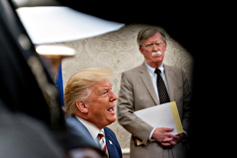 epa08493524 (FILE) - US President Donald Trump speaks as John Bolton, national security advisor, listens during his meeting with Klaus Iohannis, Romania's president, not pictured, in the Oval Office of the White House in Washington, DC, USA, 20 August 2019 (reissued 18 June 2020). According to media reports, the US government wants to prevent publication of a book by former National Security advisor Bolton, arguing that national security was at risk.  EPA/Andrew Harrer / POOL *** Local Caption *** 55406002