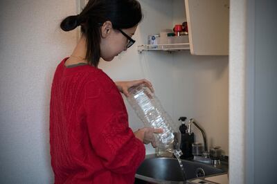 TOKYO, JAPAN - NOVEMBER 12: Ayaka Iba, a film editor from Tokyo, washes a polyethylene terephthalate (PET) plastic bottle before taking it to a recycling bin outside her apartment building on November 12, 2020 in Tokyo, Japan. Despite its size, Japan is the world's second largest exporter of plastic waste after the USA and is second only to the US in consumption of single-use plastic packaging per person. Around 10 million tons of plastic is produced a year - the third highest amount in the world - with roughly three quarters being discarded within 12 months. Although the government has made efforts recently to address the issue, it declined, along with the USA, to sign a 2017 agreement between G7 countries to reduce the amount of plastic waste in the worlds oceans and cut down on the usage of single-use plastics, such as straws, bottles and cups. Japan has one of the lowest plastic recycling rates among OECD countries - with approximately 75 percent of waste sent to incinerators where it has to be burnt using ultra-high-temperature furnaces and filter systems to avoid releasing dioxins. However, the resulting exhaust fumes contribute to climate change. (Photo by Carl Court/Getty Images)