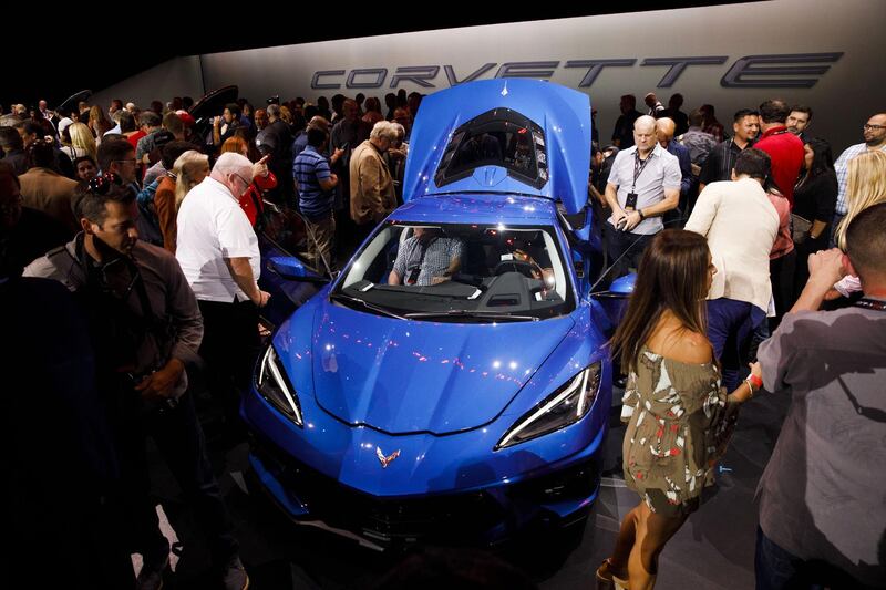 Attendees look at a new Corvette Stingray during the unveiling event. Bloomberg