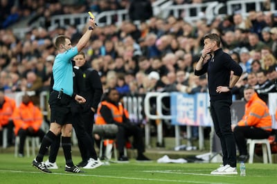 Referee Tom Bramall shows a yellow card to Luton Town manager Rob Edwards during a Premier League match against Newcastle United. Getty