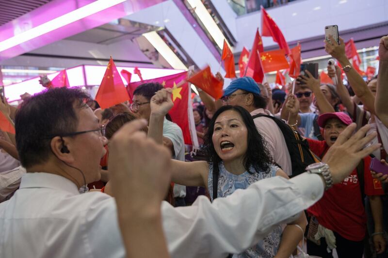 epa07841448 A pro-China supporter, (C), faces off with anti-government protesters in Amoy Plaza in Hong Kong, China, 14 Sept. 2019. Shopping malls have become the latest hot spots in the city as large numbers of pro-China supporters and anti-government protesters come to blow as they try to out-sing and out-shout each other.  EPA/JEROME FAVRE