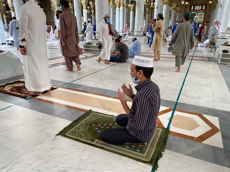 Muslim worshippers perform noon prayer at the Prophet's mosque in Saudi Arabia's holy city of Madinah. AFP