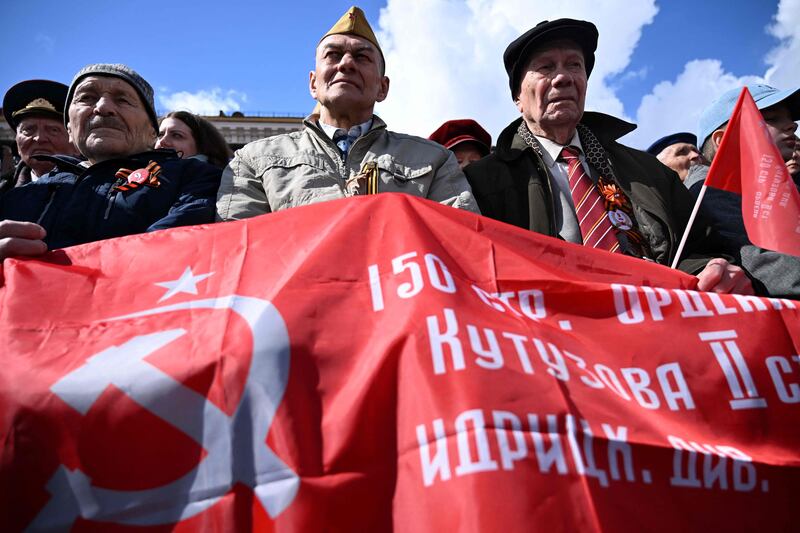 Military veterans watch the Victory Day parade in Red Square in Moscow. AFP
