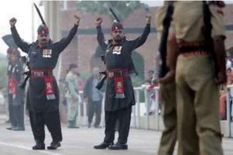 Pakistani Rangers (In Black) and Indian Border Security Force personnel perform the daily retreat ceremony on the India-Pakistan Border at Wagah on December 2,2008.  Pakistan offered to work hand-in-hand with India to track down those responsible for the Mumbai attacks but declined to respond immediately to a demand that it hand over 20 terrorist suspects. AFP PHOTO/Narinder NANU *** Local Caption ***  826304-01-08.jpg