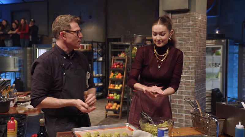 Gigi Hadid shapes falafels with chef Bobby Flay. Facebook / Food Network