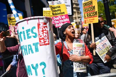 LONDON, ENGLAND - MAY 14: A woman holds a milkshake cup reading ' Want fries with that Tommy?' during a counter protest for Tommy Robinson (real name Stephen Yaxley-Lennon) outside the Old Bailey on May 14, 2019 in London, England. Mr Robinson is appearing over allegations that he committed contempt of court by allegedly filming people involved in a criminal trial and broadcasting footage on social media. (Photo by Peter Summers/Getty Images)