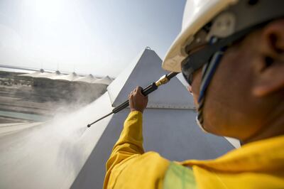 A cleaner getting rid of dust from a canopy at Yas Marina. Courtesy Seven Media