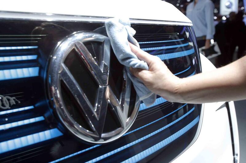 A worker shines the grill of a new VW electric car. Michel Euler / AP