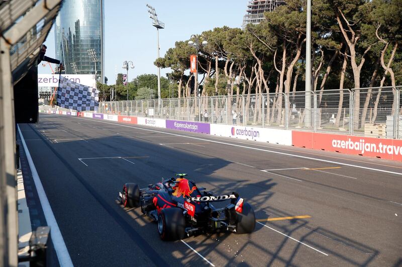 Red Bull's Sergio Perez takes the chequered flag at the Baku City Circuit. Reuters