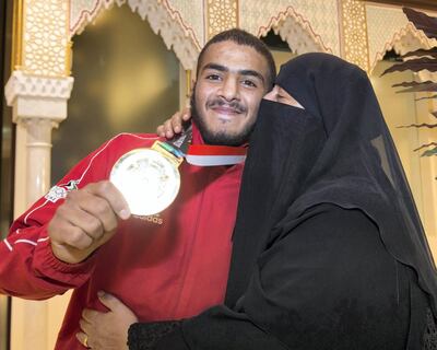 ABU DHABI, UNITED ARAB EMIRATES  27 August 2018- Hamad Nawad gold medalist 56kg division with his mother giving him a kiss at the welcome celebration for the UAE National Jiu-Jitsu team from the Asian Games (ASIAD) in Jakarta, Indonesia. The team gathered  total of 9 medals in various weight categories at Abu Dhabi International Airport VIP terminal, 27 August 2018.  Leslie Pableo for The National for Anna Zackarias story