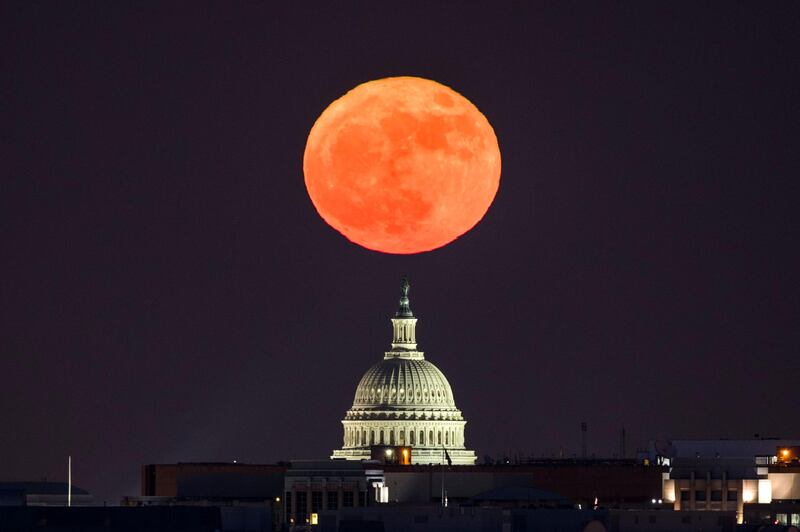 The 'supermoon' rises behind the US Capitol in Washington, DC, viewed from Arlington, Virginia, US. Jim Lo Scalzo / EPA