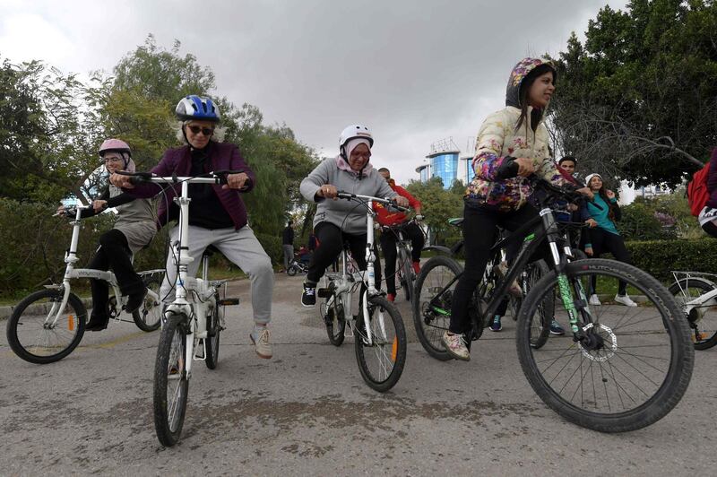 Tunisian women learn to cycle at the Japanese garden in central Tunis which is every Sunday transformed into an impromptu bicycle academy for dozens of novice cyclists on.  AFP