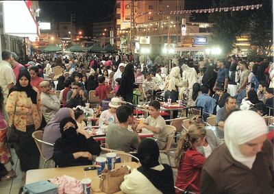 Lebanese and Arab tourists, mainly from the oil-rich Gulf states, eat outdoors in the Lebanese mountain resort of Bhamdoun, southeast of Beirut, 29 August 2002. The mountainous east Mediterranean country, seems to be regaining its pre-civil war status as the main tourist destination for rich Arabs, many of whom avoided Europe and the United States this year due to security restrictions, imposed mainly on visitors from Arab and Islamic countries, following the September 11 attacks which rocked New York and Washington in 2001. (Film) (Photo by JOSEPH BARRAK / AFP)
