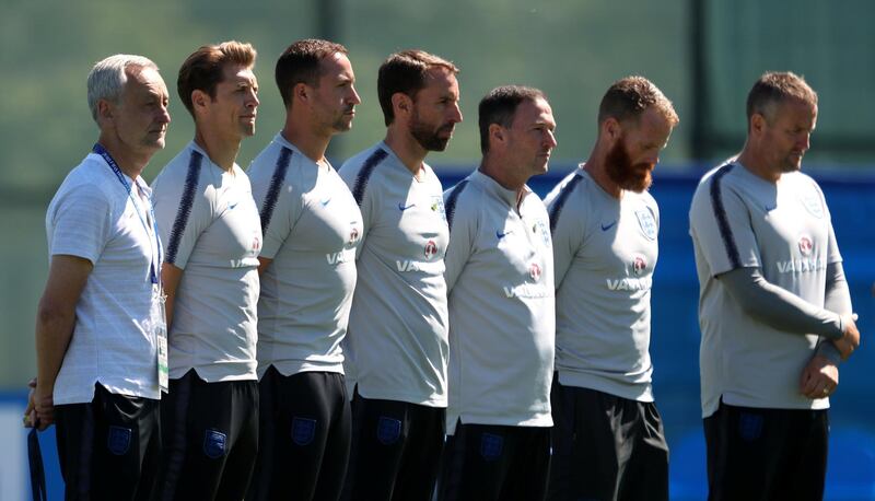 England manager Gareth Southgate, centre left and his coaching staff during a minute's silence to honour the anniversary of the Grenfell Tower fire at England's World Cup training camp in Saint Petersburg. Lee Smith / Reuters