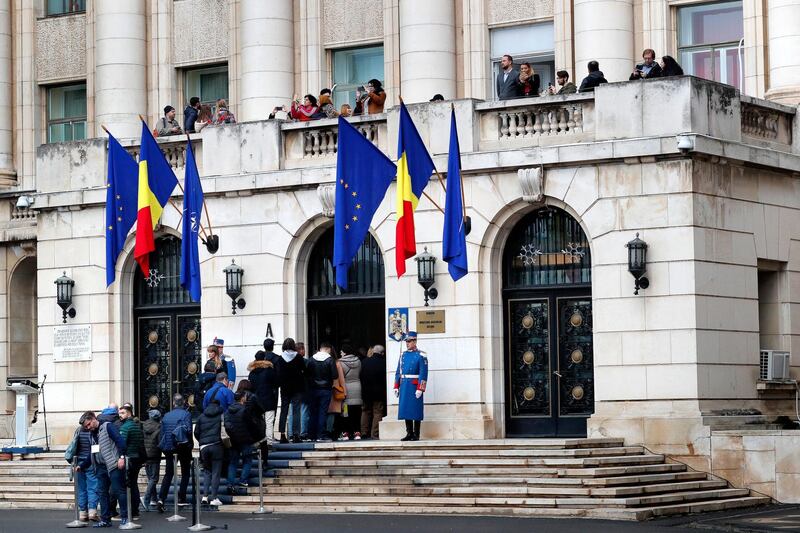 epa08087867 People queue to visit the Interior Ministry headquarters building, as visitors watch the panorama from the balcony were dictator Nicoale Ceausescu was seen for the last time during an open doors day marking the 30th anniversary of the 1989 revolution, in downtown Bucharest, Romania, 22 December 2019 (issued 23 December 2019). (issued 23 December 2019). On Sunday 22 December 2019, the building of the Ministry of Internal Affairs was open to the public for four hours, starting on 12:09, the time at which 30 years ago the former communist dictator Nicolae Ceausescu and his wife Elena rushed out of Bucharest with a helicopter from the roof of the building. The Open Doors day at the headquarters of the former Central Committee (CC) of the Romanian Communist Party (PCR), the place from were Ceausescu was ruling the country, was organized for the first time in 30 years. The public had access to places such as the arrest cells of the former communist intelligence service called Securitate, the working bureau of Ceausescu, the balcony from the first floor, from where Ceausescu addressed for the last time to Romanians, as well as the inner court of the institution, where holes from the bullets drawn in 1989 can still be seen on the walls. Thousands of people visited the former CC building where the events of the December 1989 revolution started, some of it being transmitted live on national TV station (TVR).  Romanians these days pay their respect to the 1989 activists who took to the streets 30 years ago, taking part at the revolution that toppled Eastern Europe's most repressive communist regime. More than 1,100 people were killed across Romania, mostly young people who had gone out to fight for a free and prosperous future. In the future, the Interior Ministry management intends to transform the building into a museum.  EPA/ROBERT GHEMENT