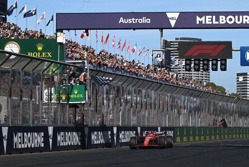 Carlos Sainz takes the chequered flag to win the Australian Grand Prix. EPA