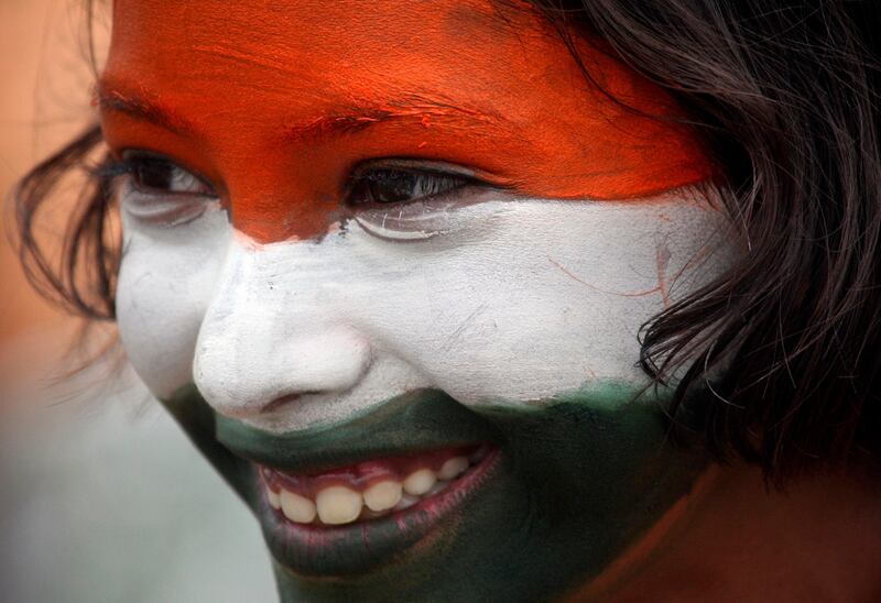 A school girl, with her face painted in the colours of India's national flag, takes part in a cultural program to celebrate India's Independence Day in the northern Indian city of Chandigarh August 15, 2011. REUTERS/Ajay Verma (INDIA - Tags: ANNIVERSARY SOCIETY HEADSHOT) *** Local Caption ***  DEL05_INDIA-_0815_11.JPG