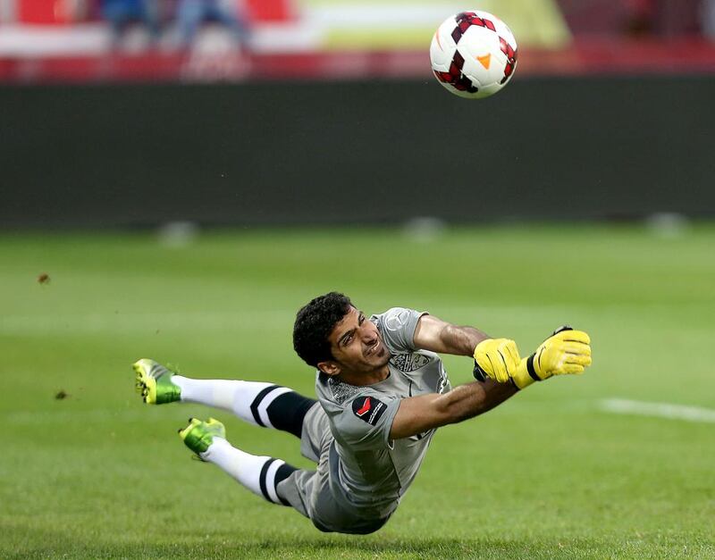 Al Ahli’s keeper Saif Yousuf blocked a penalty kick in the 40th minute to deny Al Dhafra. Sammy Dallal / The National