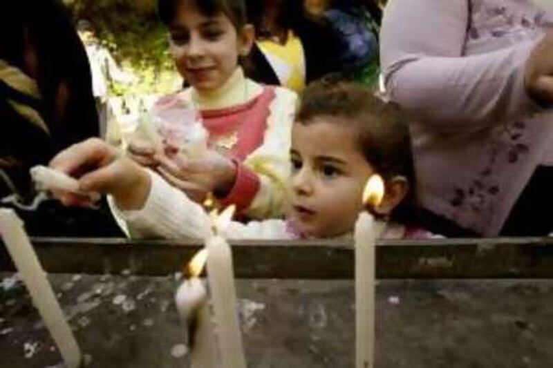 BAGHDAD, IRAQ, DECEMBER 25:  Iraqi Christians light candles after attending Christmas mass at the Virgin Mary church on December 25, 2008 in Baghdad, Iraq. Iraqi Christians celebrated Christmas as security continues to improve in the Iraqi capital of Baghdad. Although there has been some reduction in violence in Iraq, the US Commission on International Religious Freedom expressed its concern about  "severe abuses of religious freedom" of non-Muslim Iraqis which include ChaldoAssyrian Christians, other Christians, Sabean Mandaeans, and Yazidis.   (Photo by Wathiq Khuzaie/Getty Images) *** Local Caption ***  GYI0056404821.jpg