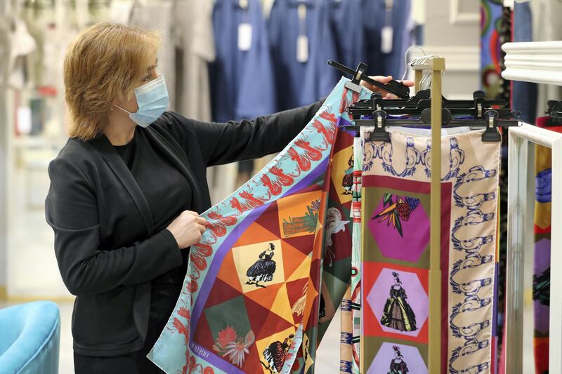 Dubai, United Arab Emirates - Reporter: Panna Munyal. Fashion. Shopping. A lady looks at scarfs by Oriquo. Pop-up of eight Italian boutique brands at Galeries Lafayette at The Dubai Mall. Tuesday, March 23rd, 2021. Dubai. Chris Whiteoak / The National