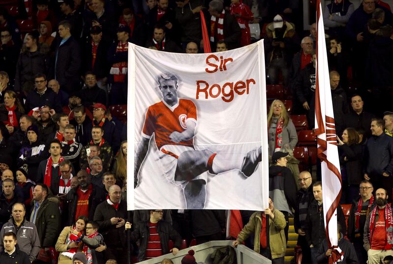 Liverpool fans hold up a banner for former player Roger Hunt. Alamy