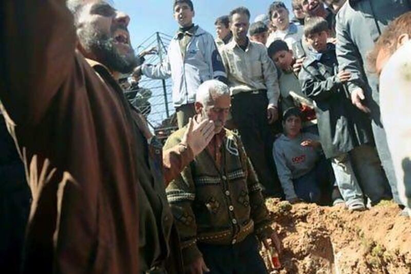 Syrians prepare to bury 13-year-old Ahmad bin Muhsin Qarush during his funeral on March 24, 2012. He was reportedly killed two days earlier in shelling by regime forces in the northwestern city of Sermin. in Syria.