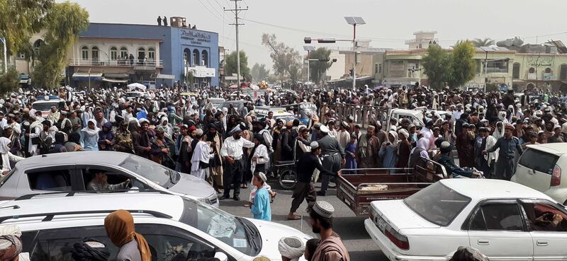 Police officers conduct their duties after the Taliban took control of Kandahar.