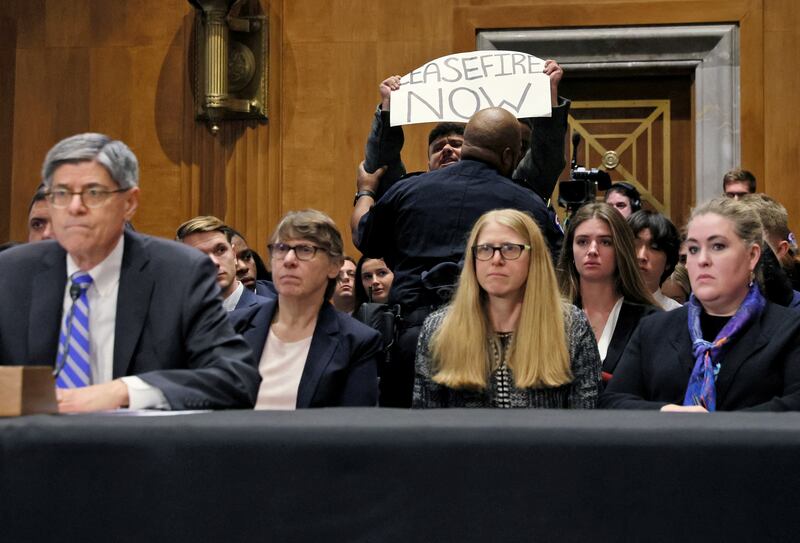 A protester is removed by police at Jack Lew's confirmation hearing. Reuters