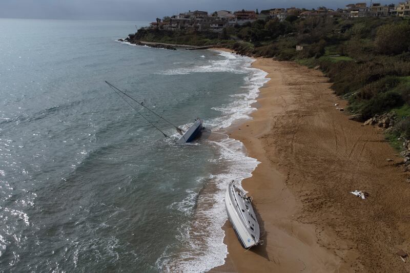 Sailboats used by smugglers to transport migrants and refugees are left abandoned on a beach in southern Italy. AP