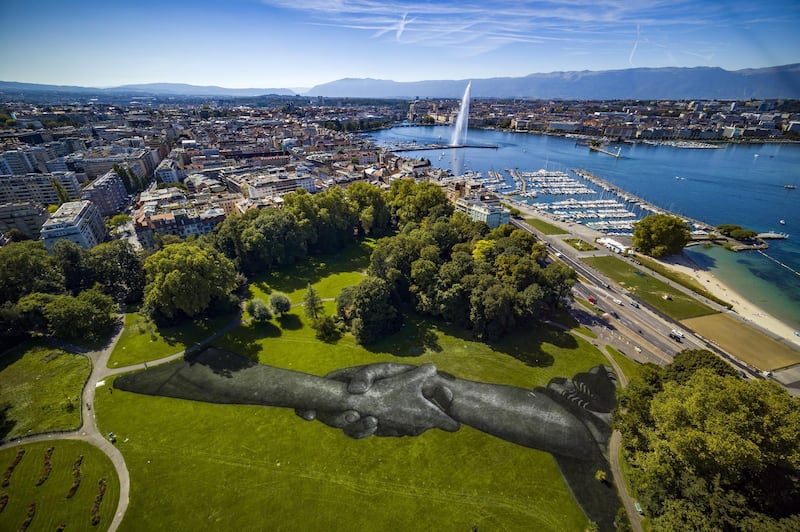 A picture taken with a drone shows a view of a giant biodegradable landart painting by French-Swiss artist Saype at the Parc de la Grange in Geneva, Switzerland.  EPA