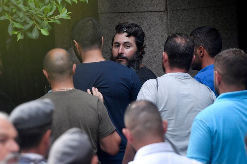 Bassam al-Sheikh Hussein, an armed man who took hostages, leaves the branch of a Federal bank in Beirut, Lebanon, 11 August 2022.  According to initial reports, an armed man stormed a Hamra-based bank and is keeping employees and clients as hostages demanding to be given his deposits.   EPA / WAEL HAMZEH