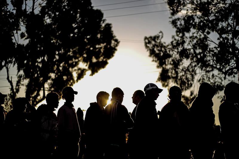 Members of the Central American migrant caravan stand in a queue at a shelter in the city of Tijuana, Baja California.  EPA