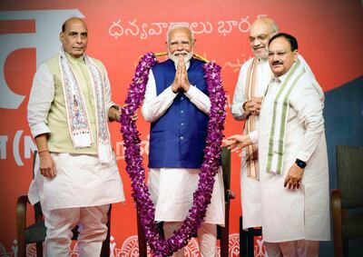 Indian Prime Minister Narendra Modi is garlanded by senior Bharatiya Janata Party leaders Rajnath Singh, left, party president J P Nadda, right, and Amit Shah, at the party headquarters in New Delhi, on Tuesday.  AP 