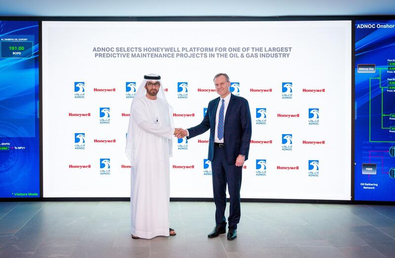 Adnoc Group chief executive Dr Sultan Al Jaber and Honeywell chairman and chief executive Darius Adamczyk shake hands following the 10 year-partnership agreement. Courtesy Adnoc Group.