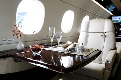 A table is set for dining aboard an Embraer SA Legacy 500 jet at the Singapore Airshow held at the Changi Exhibition Centre in Singapore, on Wednesday, Feb. 17, 2016. Embraer expects to win new customers in Asia Pacific, a region the Brazilian planemaker says will account for a quarter of the world's demand for small passenger jets. Photographer: SeongJoon Cho/Bloomberg